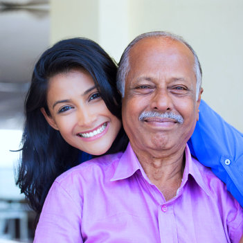 caregiver and senior man smiling