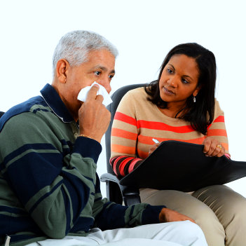 therapist talking to senior man