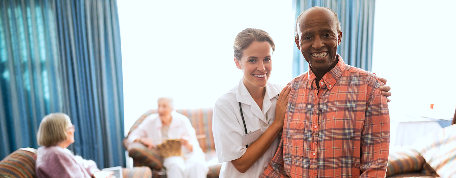 caregiver and senior man smiling