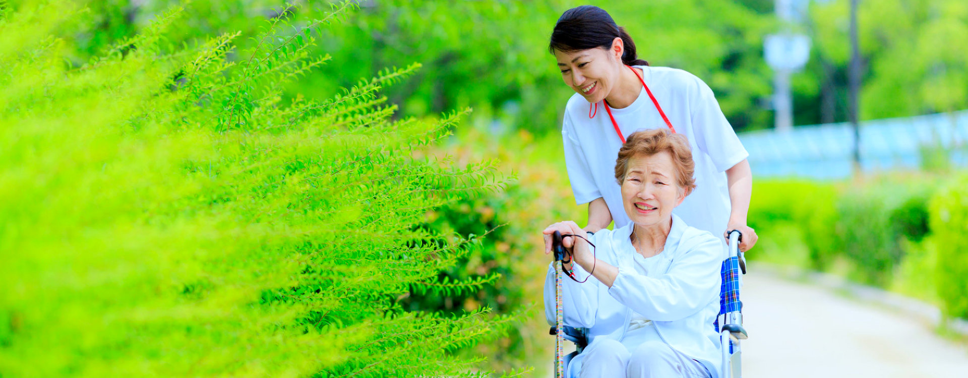 caregiver assisting senior woman in wheelchair