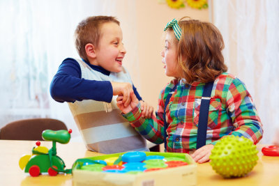 special children holding hands and smiling