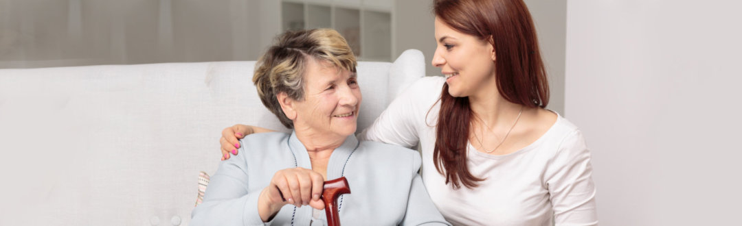 senior woman and adult woman looking at each other and smiling
