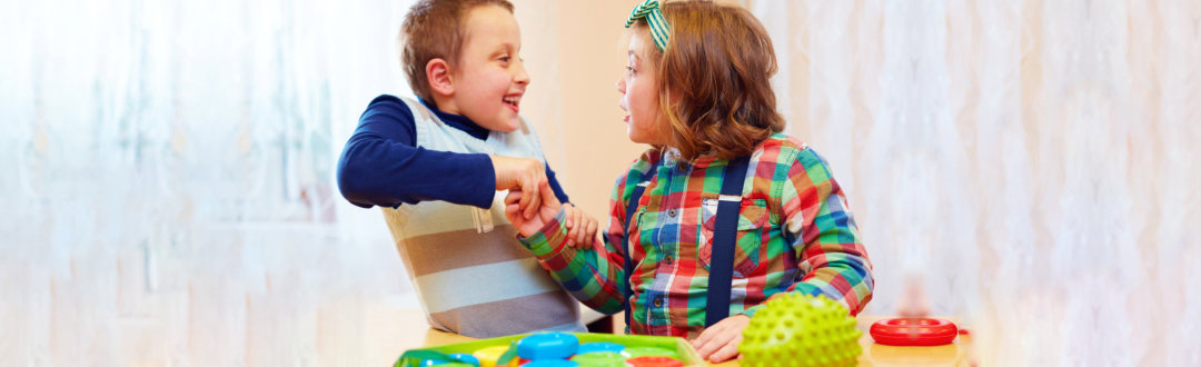 special children holding hands and smiling