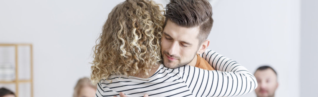 adult man and adult woman hugging each other