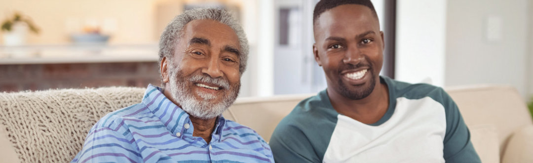 senior man and adult man are smiling