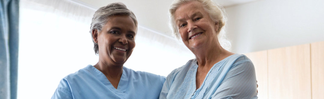 caregiver and senior woman smiling