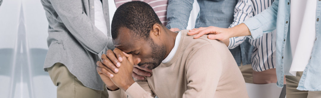 adult man being comforted
